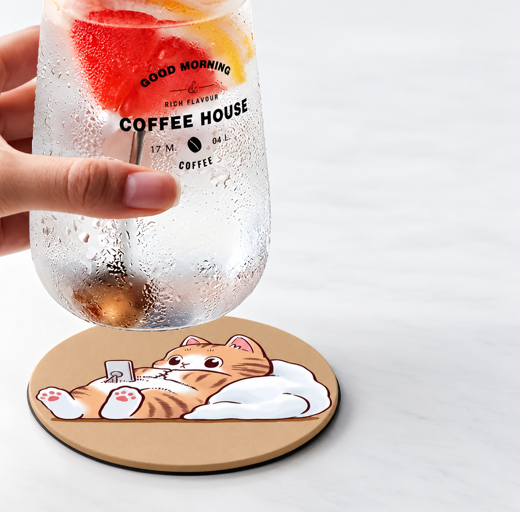 Orange cat coaster beneath a glass with condensation.