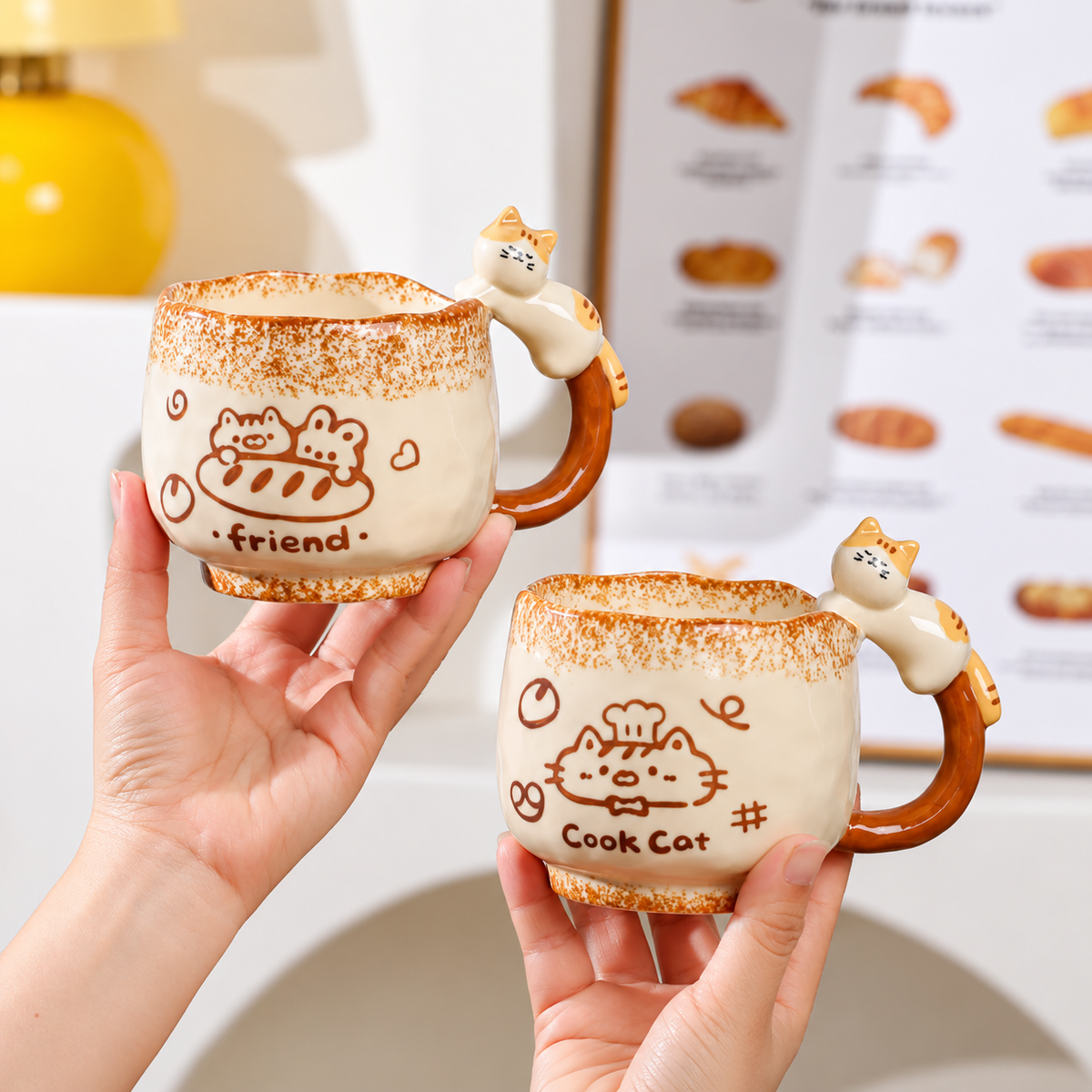 Friend and Cook Cat vintage ceramic mugs with speckled rims and sculpted cat handles, held side by side.