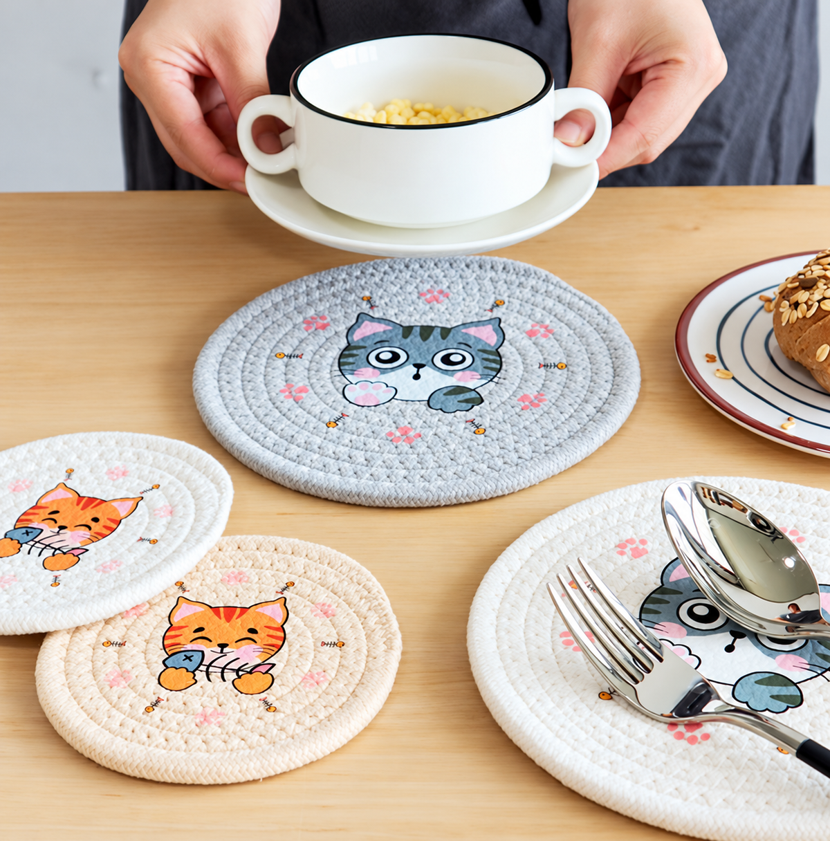 Gray and orange cat rope coasters styled with a bowl and tableware.