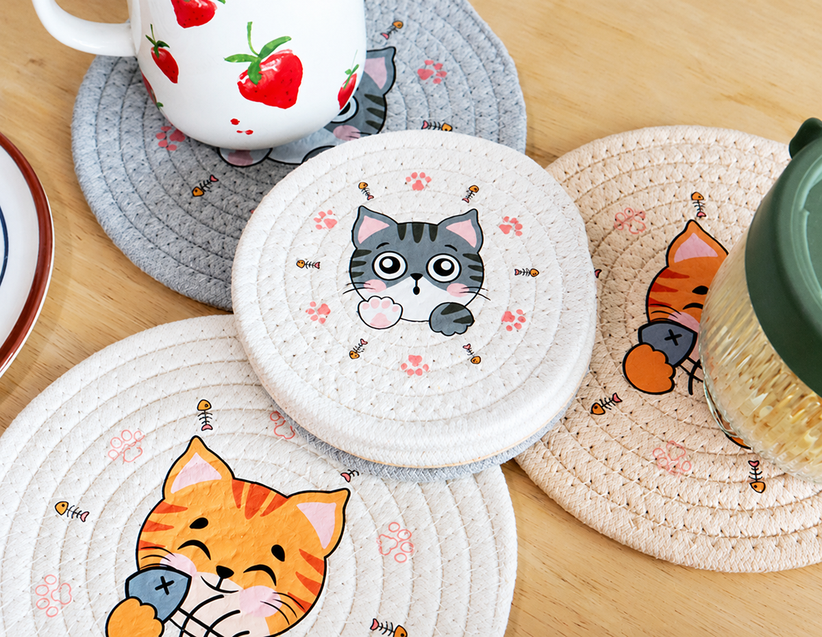 Four printed cat coaster styles in ivory, khaki and light gray woven rope.