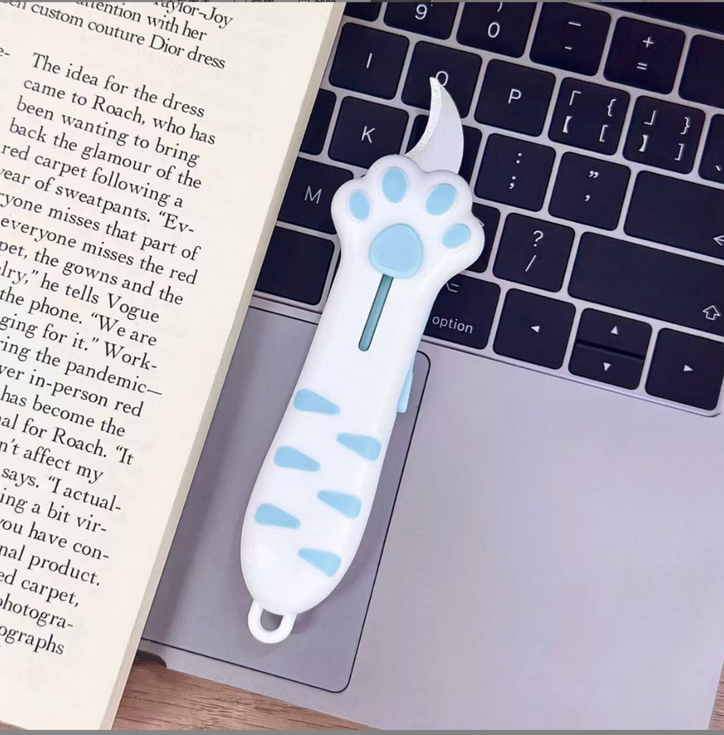White / Blue cat paw retractable box cutter with blue paw pads and a curved stainless steel blade.