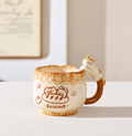 Friend ceramic cat mug with brown illustrations and a sculpted cat on the handle.