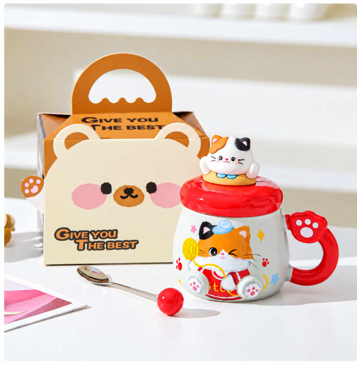Red cat mug with matching lid, spoon and handled gift box.