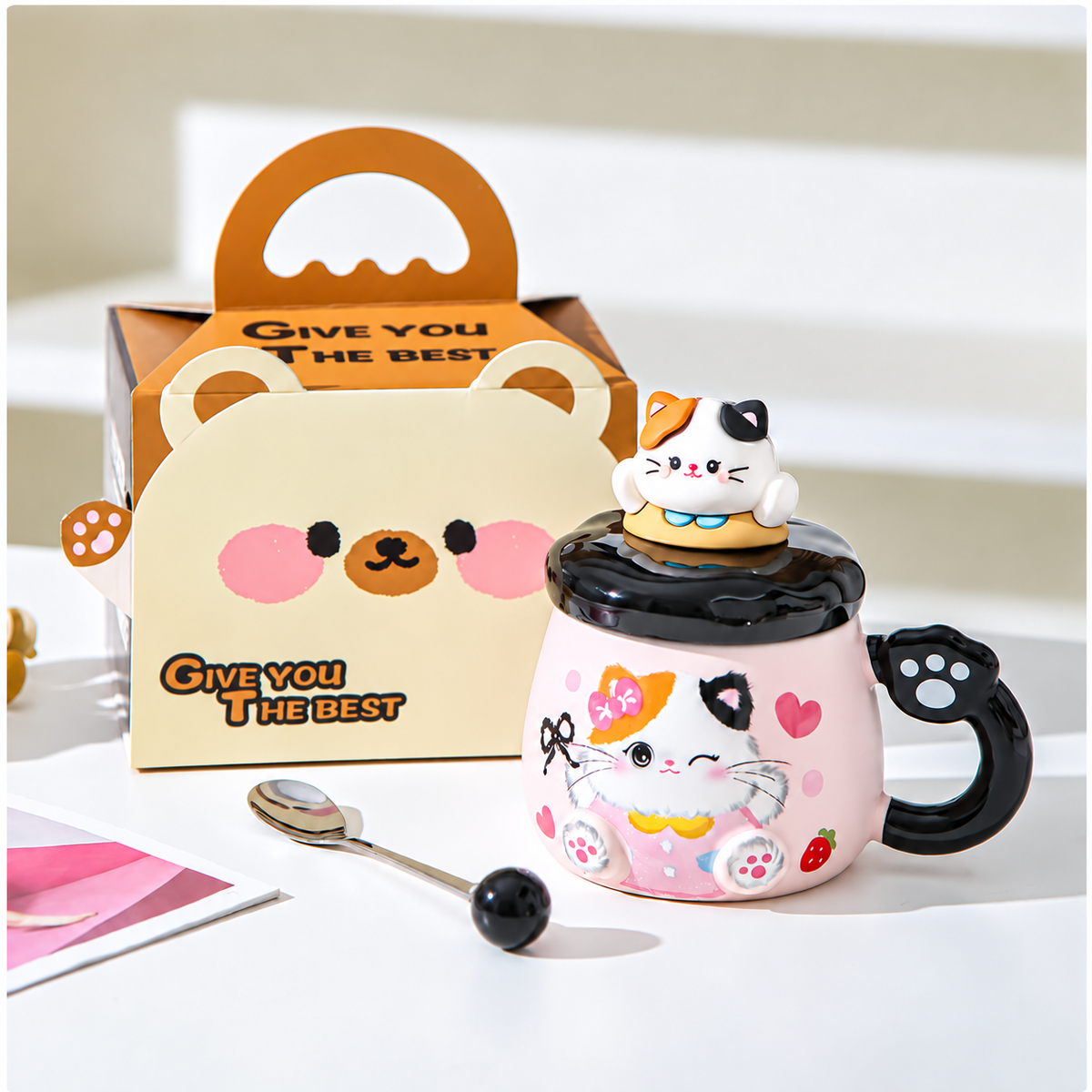 Black-accent cat mug with matching lid, spoon and handled gift box.